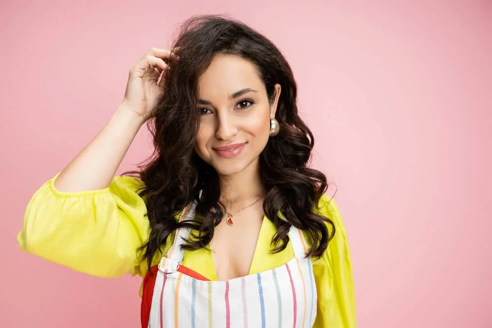 How to Use Curlers for Extra Volume in Your Hair Overnight 1 A female with bouncy curls created with velcro rollers on damp hair without using a curling iron or hot roller.
