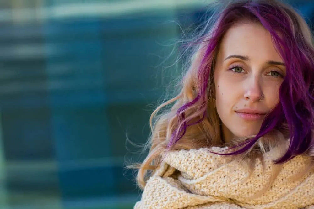 How to Get Hair Dye Off Forehead: DIY Step-by-Step Guide 1 A female with a purple and dark blonde hair color has leftover hair dye on her stained skin from an at-home dye job.