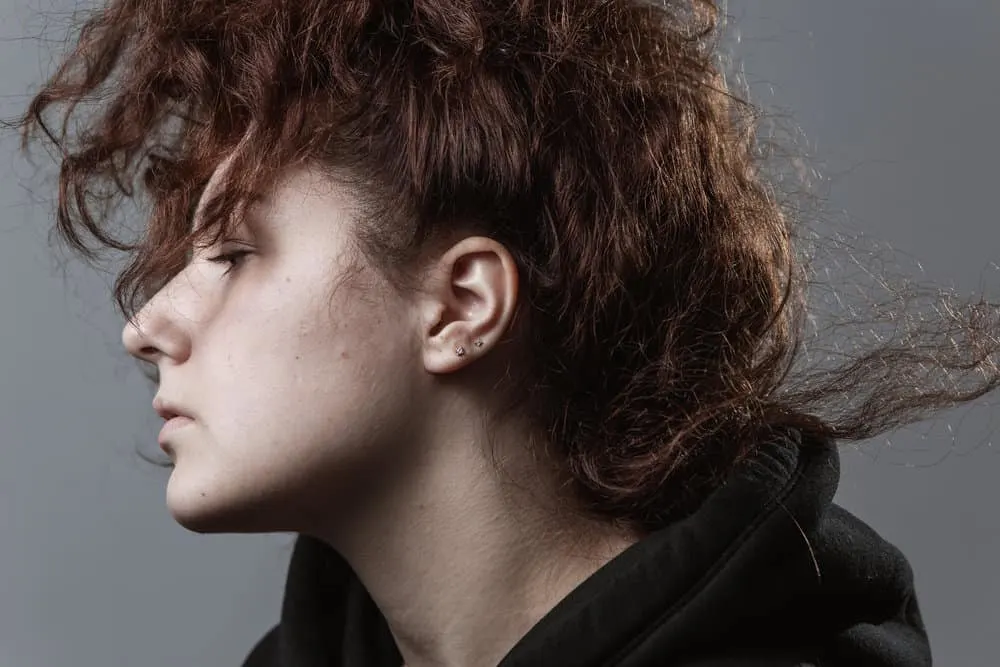 How to Fix Dead Hair Follicles at Home Without Cutting It 5 A disappointed female has heat damage on dyed hair that's been treated with coconut oil and almond oil.