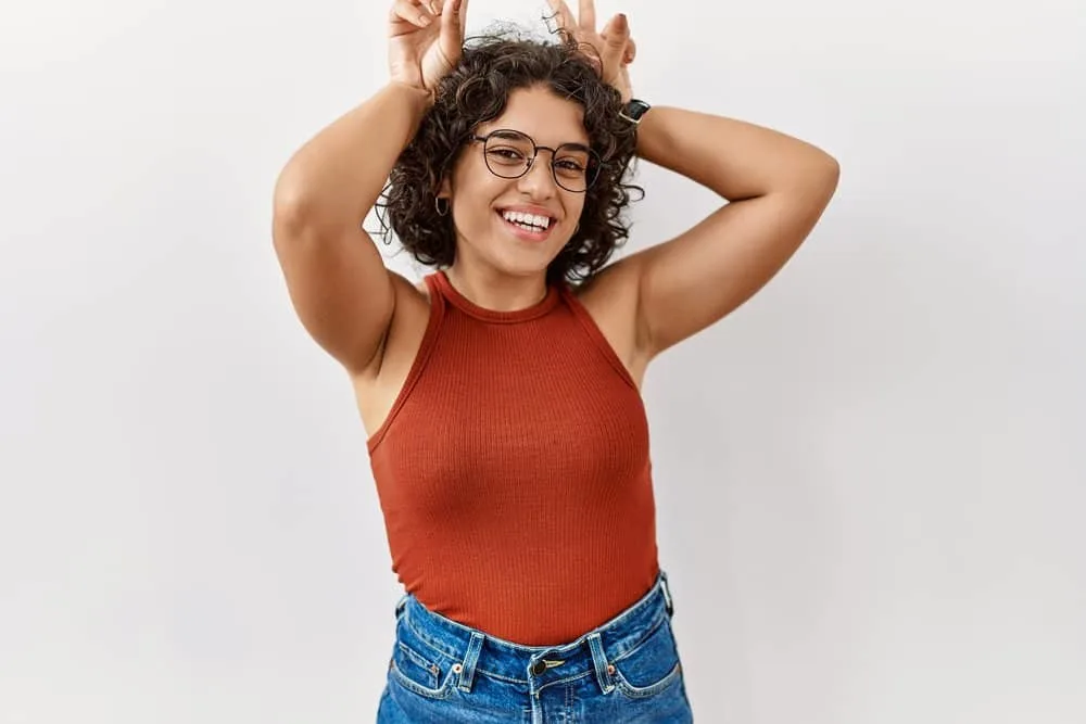 Do Mexicans Have Curly Hair? Is Curly Hair Common in Mexico? 4 A cute native American female from Latinx culture is wearing her naturally curly hairstyle.