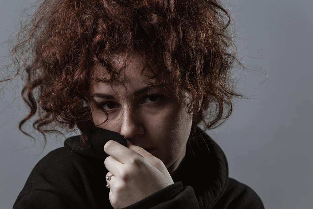 A young white girl that wants to keep her hair healthy currently has dry and damaged hair from heat tools.