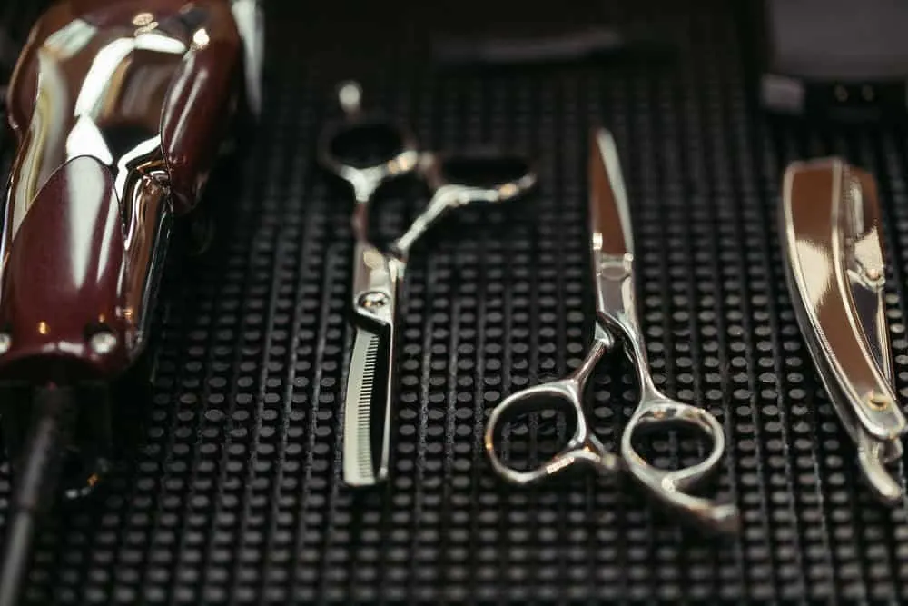 How to Sharpen Clipper Blades With and Without a Stone 9 A comb blade, new pair of haircutting shears, a straight razor with a sharp edge, and my own clipper blades.