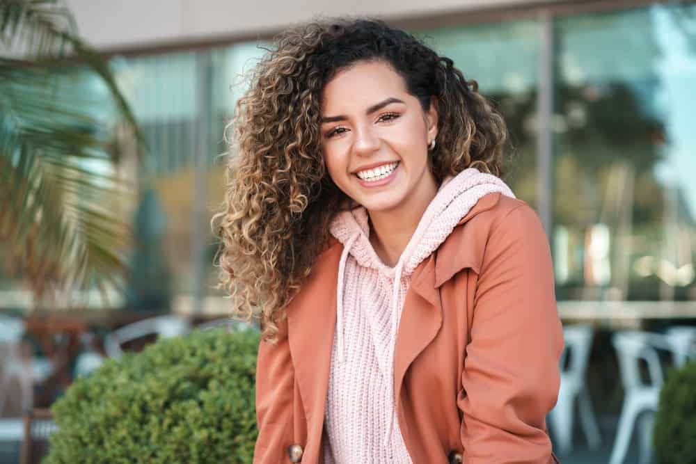 A young Latin female had dry hair before using a hair mask to keep her damaged hair moisturized with natural oils.