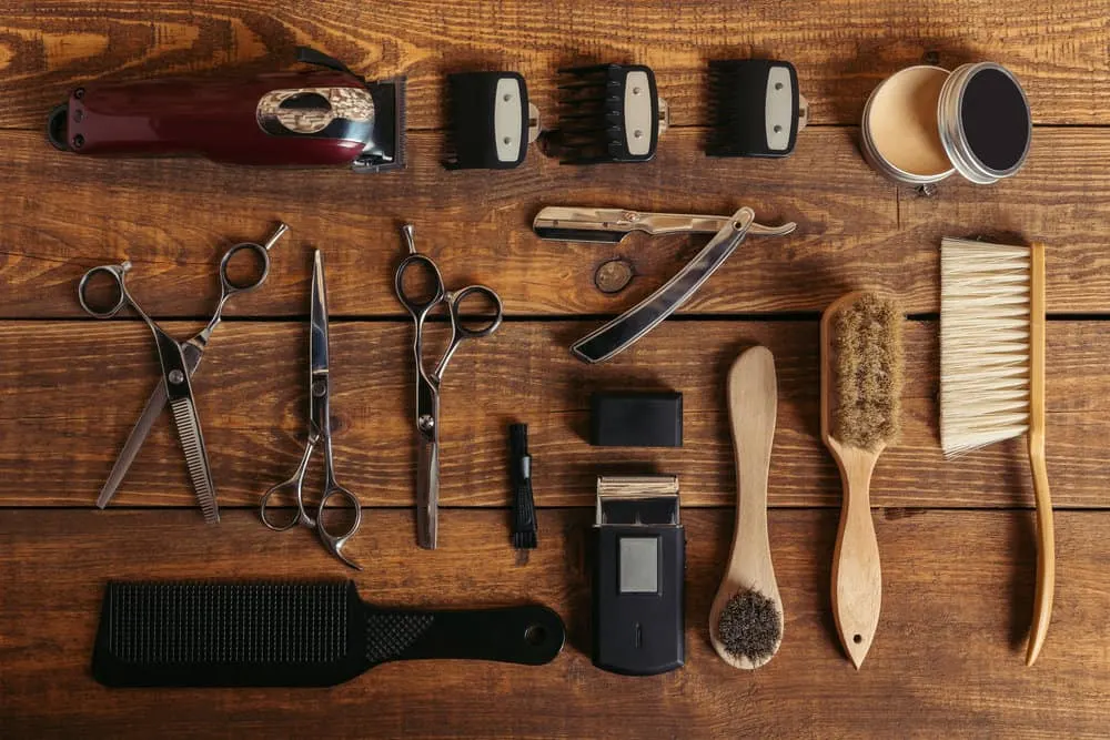 How to Sharpen Clipper Blades With and Without a Stone 11 A set of equipment at a local barbershop showing clippers with a ceramic blade, a honing stone, and new blades.