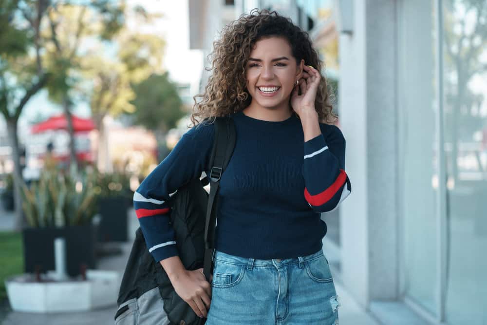 A beautiful light-skinned female that used moisturizing products specifically designed for a straight-to-curly transition.