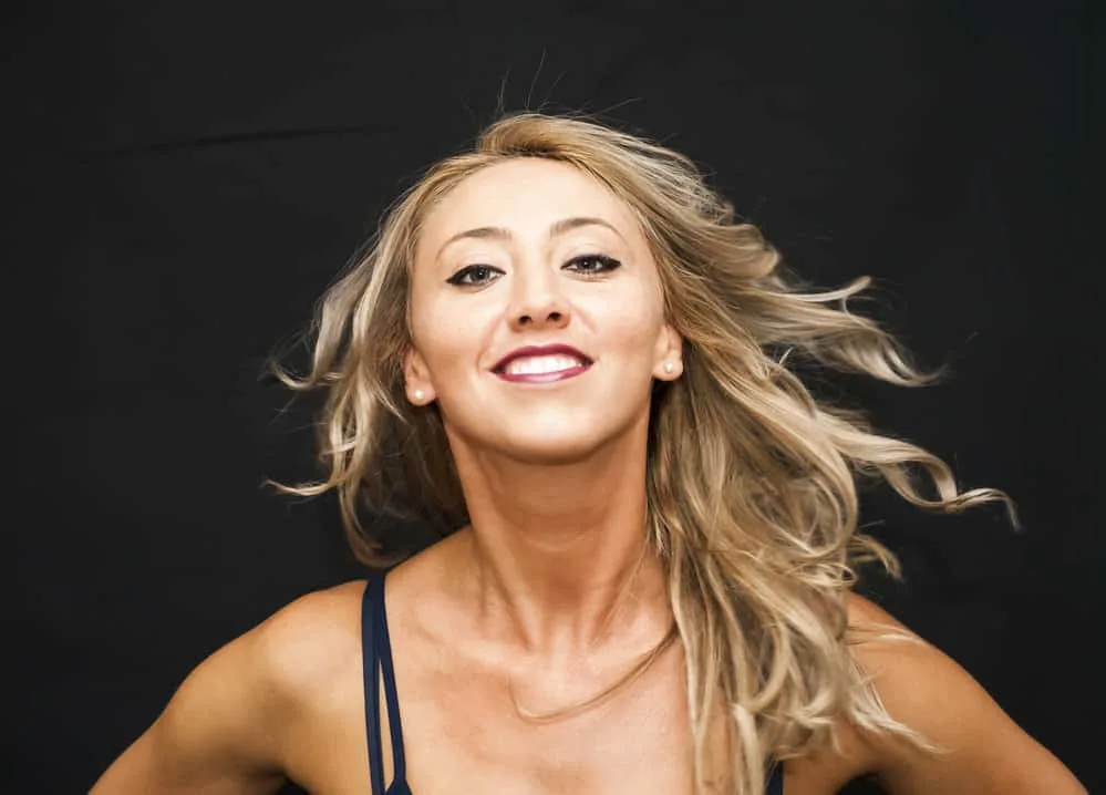 How to Feather Hair in 70s Style at Home With a Flat Iron 4 A lady shows there are several ways to style feathered hair with curtain bangs and long layers with volumizing mousse.