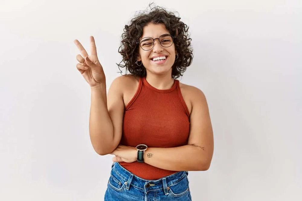 Do Mexicans Have Curly Hair? Is Curly Hair Common in Mexico? 7 A playful young Mexican female wearing a casual outfit styled her curly textured hair without excessive heat.