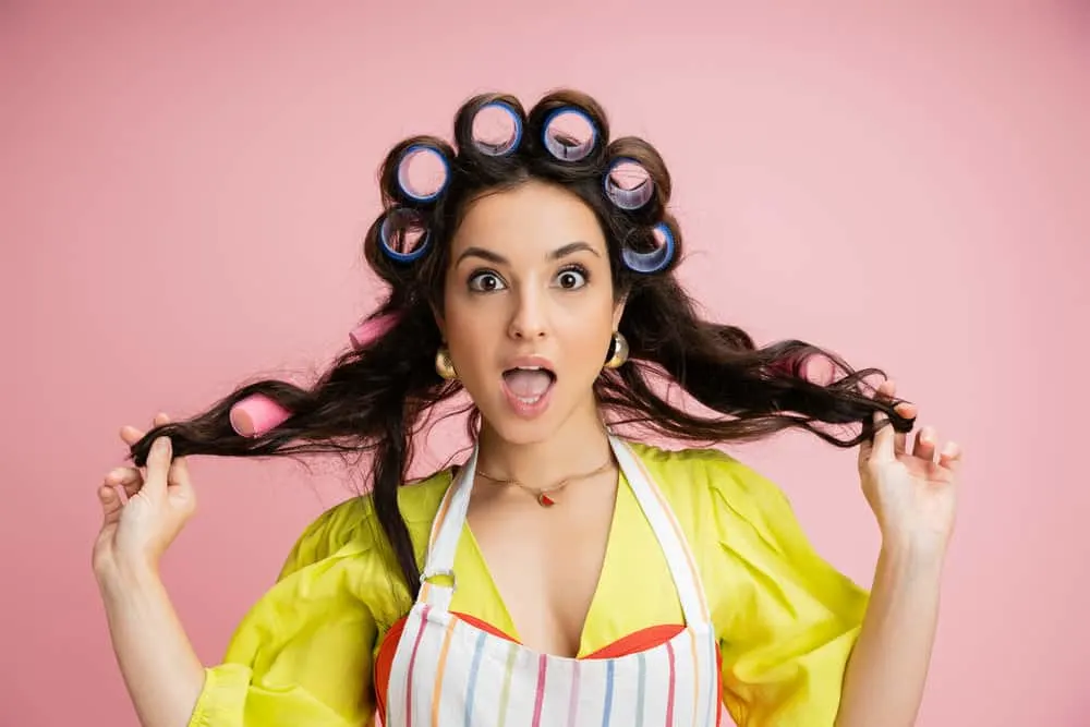 How to Use Curlers for Extra Volume in Your Hair Overnight 5 A cute white girl with a big personality and natural long hair wearing velcro rollers and smaller rollers on dry hair.