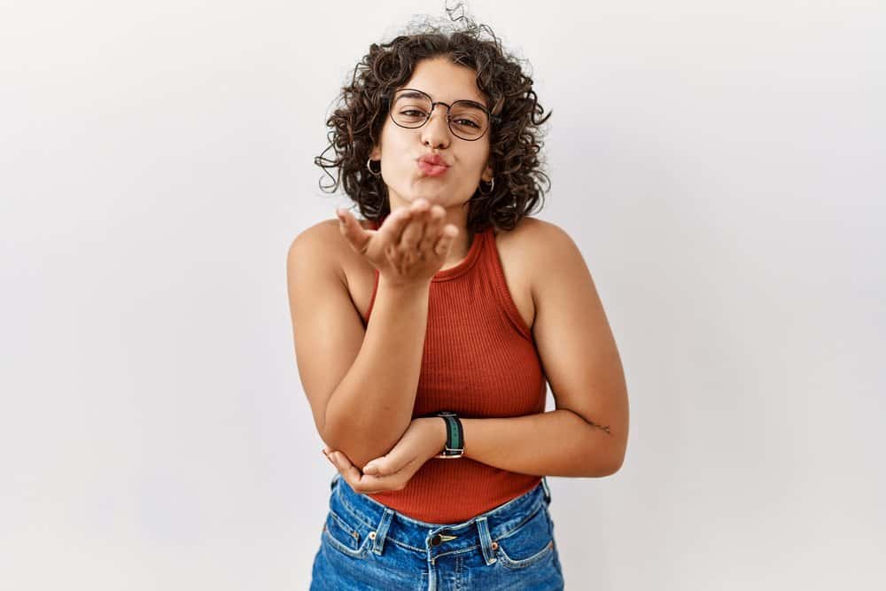 Like many Mexicans, a young Mexican female with curly or wavy hair strands is a Latin American.