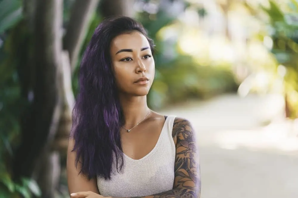 Is Redken a Good Brand for Your Hair or Is It Bad for Curls? 5 A cute Asian female with color-treated hair washed with a specialized shampoo from the Redken all-soft line.