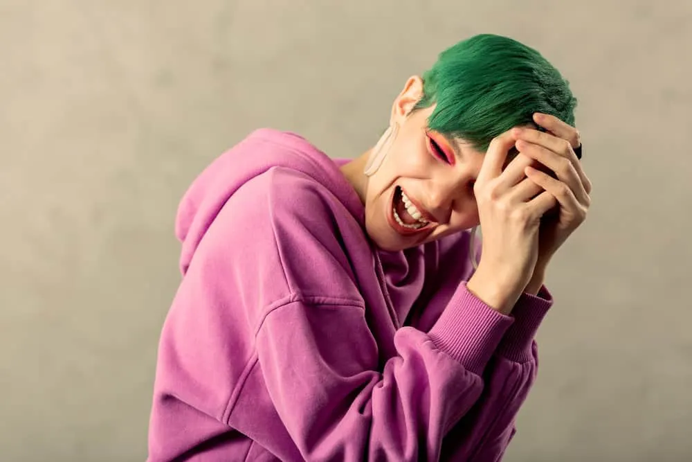 Fading Green Hair: How to Fade Green Dye Fast Step-By-Step 3 A delighted lady colored her hair green with semi-permanent hair dye - much darker than her natural hair color.