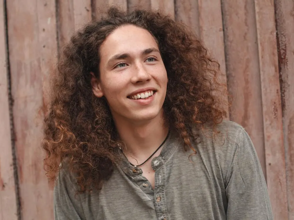 Wolf Cut: Men Hairstyle Tutorials with 9 Step-by-Step Videos 17 A man with a curly hair type styled with a round brush after being washed and dried with a blow dryer.