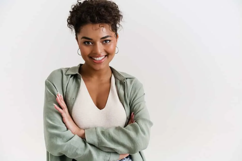 Can Micellar Water Remove Hair Dye From Skin? All Skin Types? 4 A woman wearing a green jacket and beige shirt has a hair dye stain on her forehead after using DIY box hair color.