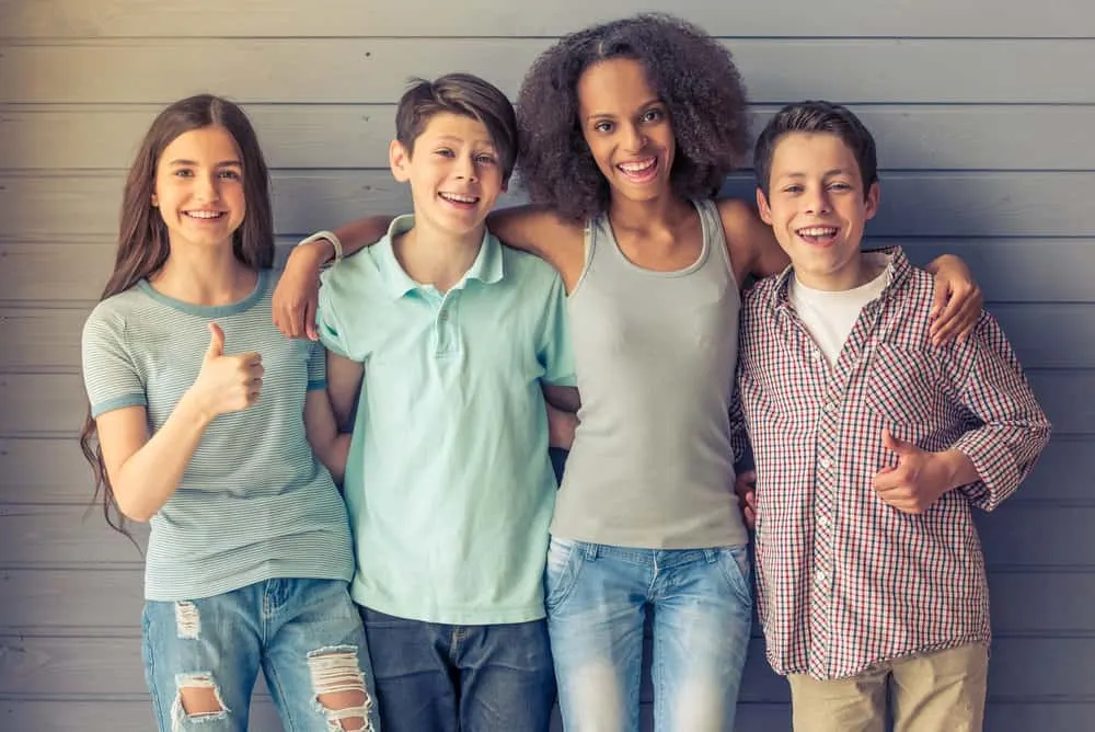 Popular 80s Teenager Hairstyles for Black and White Girls 14 Four teens from the 80s era, all wearing their go-to hairstyle with casual funky rock clothing with bright colors.