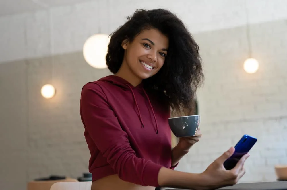 Is BioSilk Good for Your Hair? What About Their Shampoo and Conditioner? 2 A cute black girl with slightly wet hair after washing her hair and styling with natural pure silk hair serums.