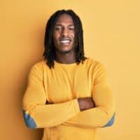 African American male with a tight curl pattern is wearing freeform dreadlocks on his 4B natural hair texture.