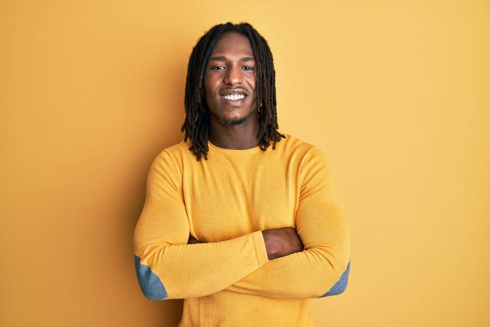 African American male with a tight curl pattern is wearing freeform dreadlocks on his 4B natural hair texture. 