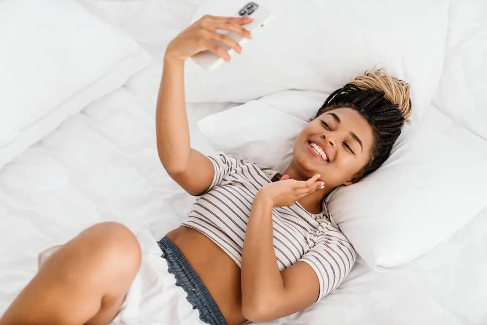 Microlocs vs. Sisterlocks: What's the Difference? Which is Better? 11 A beautiful female takes a selfie of her fantastic hair growth after wearing both microlocs and sisterlocks.