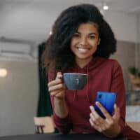 A black girl with frizzy hair before using BioSilk Therapy Serum to make her colored hair soft and absolutely amazing.