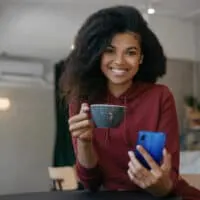 A black girl with frizzy hair before using BioSilk Therapy Serum to make her colored hair soft and absolutely amazing.