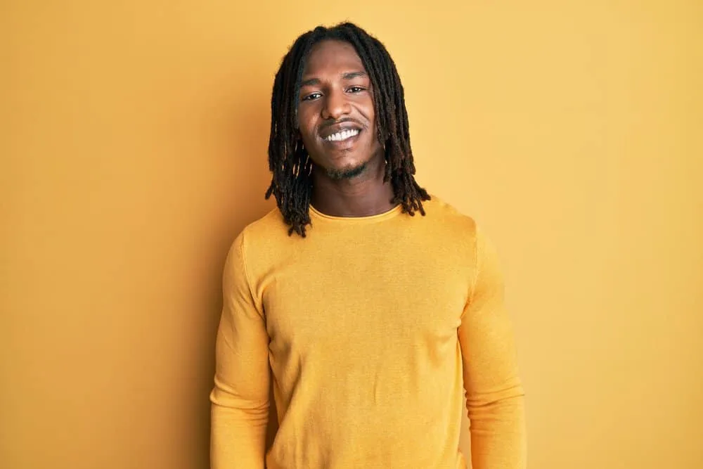 African male with thicker locs that have a polished appearance after being allowed to shape naturally.