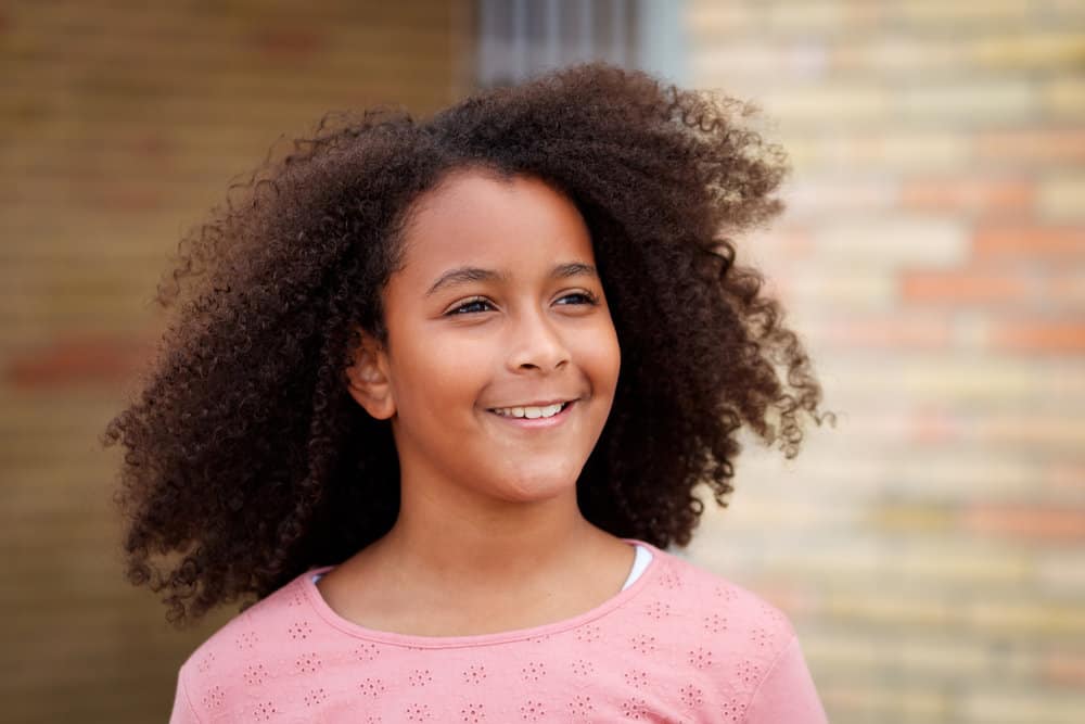 Image of Messy top knot hairstyle for 12 year olds