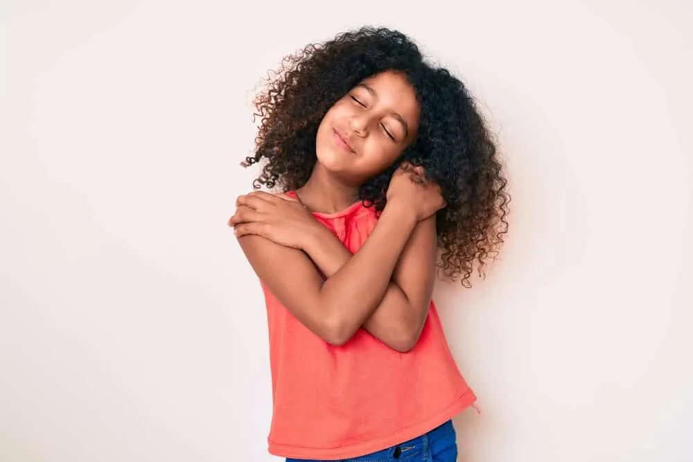 15 Cute and Easy Hairstyles for 10-Year-Old Black Girls 14 Adorable young black girl wearing a cute hairstyle after removing simple cornrows to a picture day finished look.