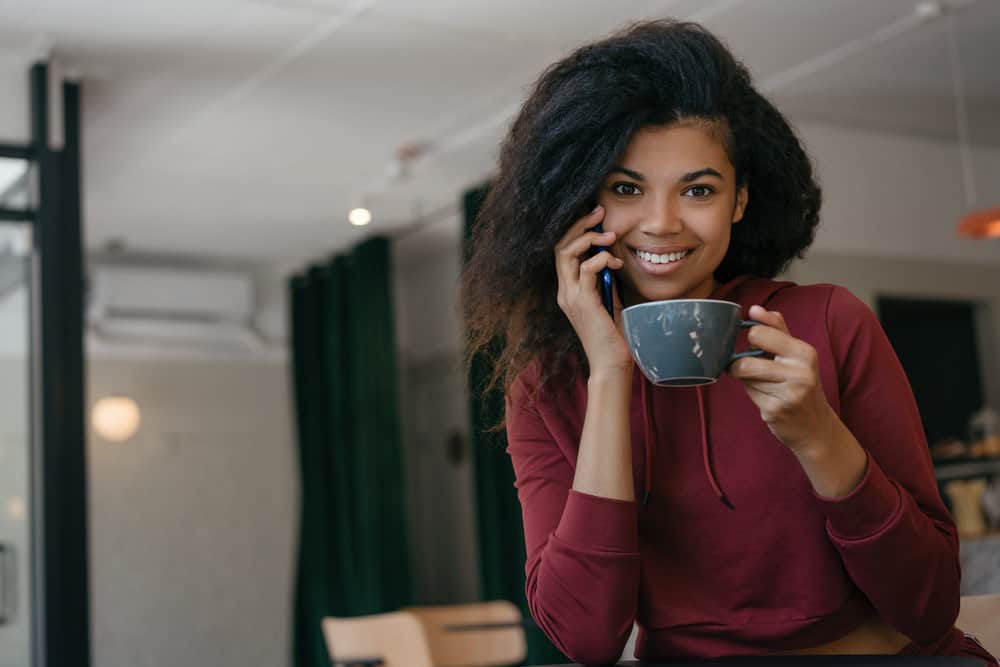 An African American female is talking to her mom on the phone about using BioSilk Silk Therapy Original silk protein.