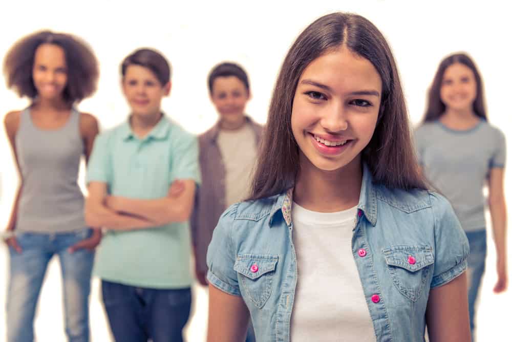 A cute teenage girl in the punk movement with a straight hairstyle created with a rat tail comb.