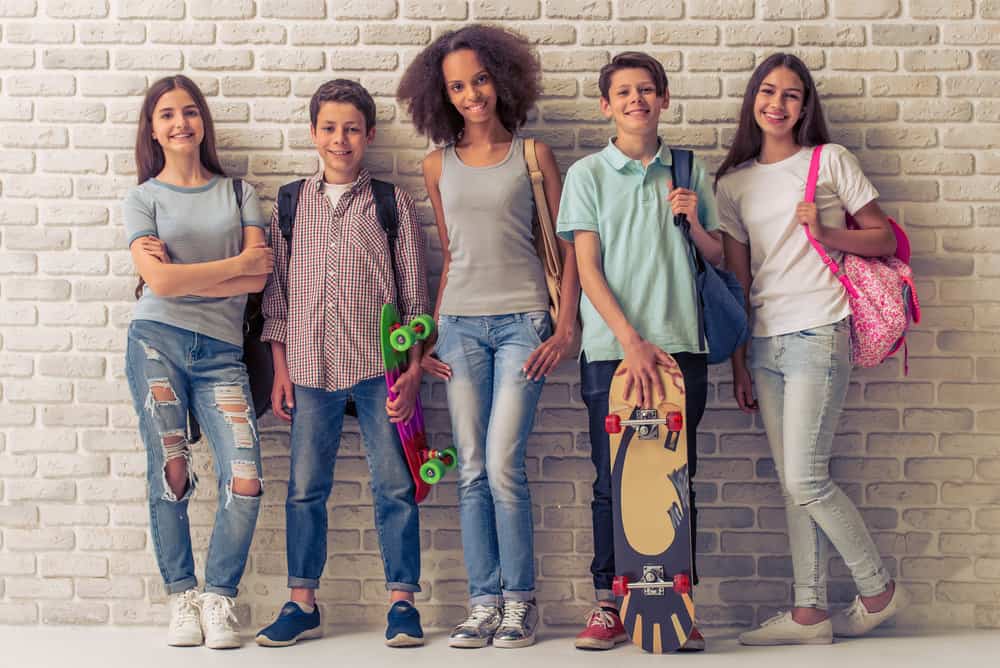 A group of teenagers with a great mix of different hair styles, including some with short hair and hair bands.