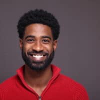 A young African American male with facial hair growth after eating a healthy diet to encourage healthy hair follicles.