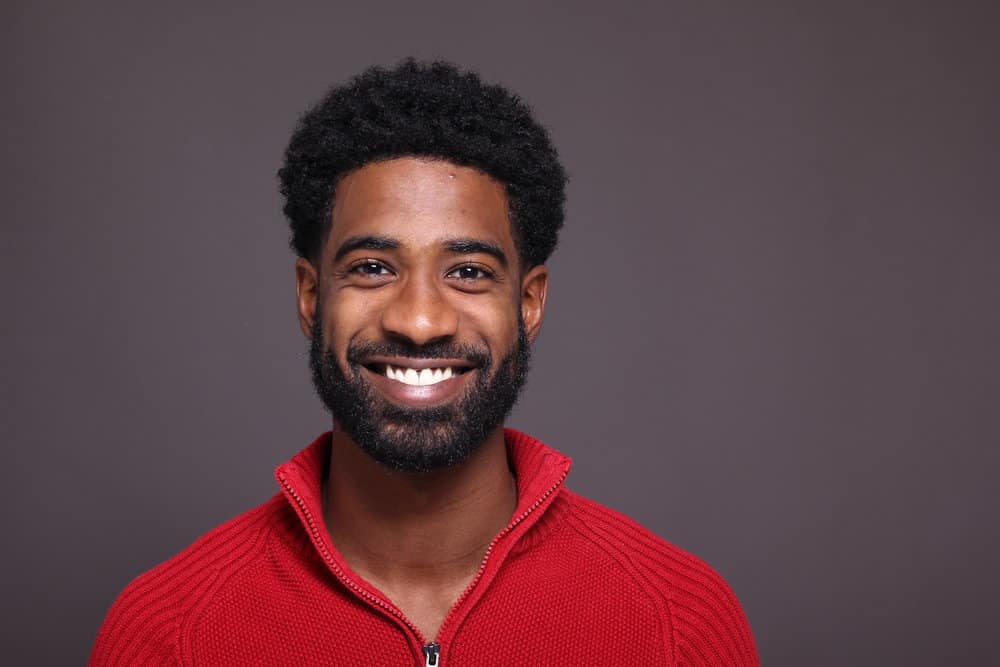 A young African American male with facial hair growth after eating a healthy diet to encourage healthy hair follicles.