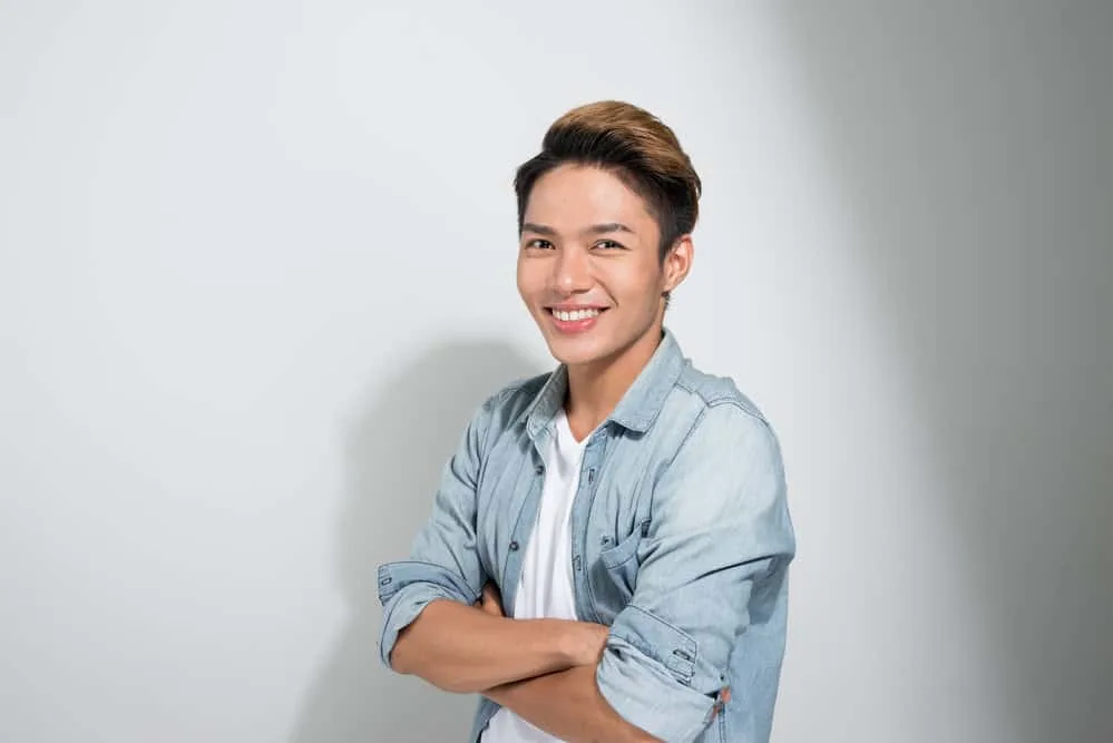 Asian Men Hairstyles: 15 Best Hairstyles for Asian Guys 1 A confident Asian male with a casual style and thick hair wearing a high fade style on his 1C hair type.