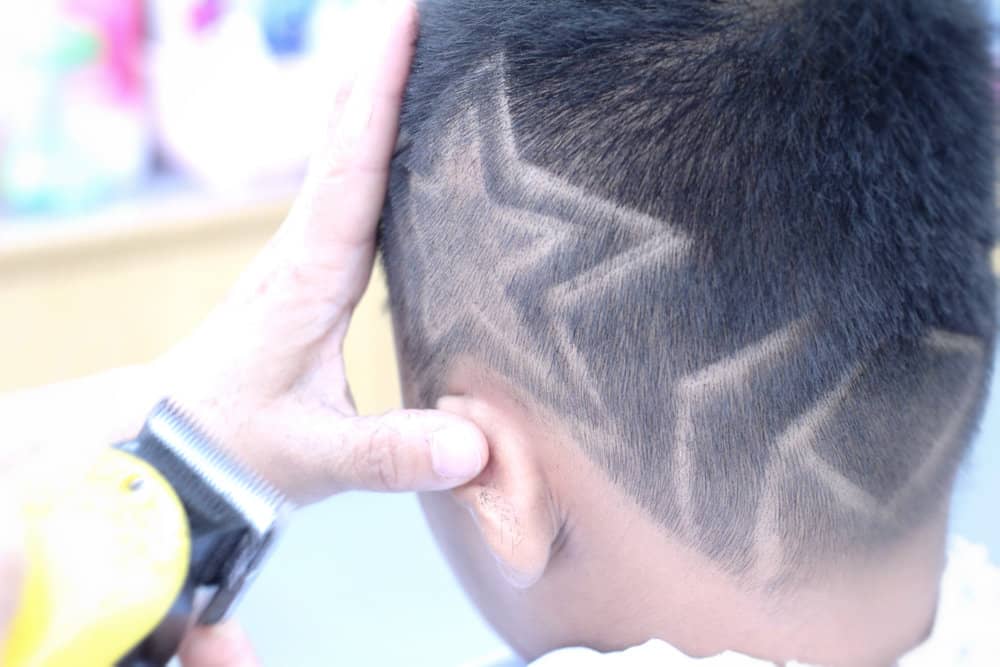 The straight-line haircut on dark hair is the perfect choice for this little boy with an oval face shape.