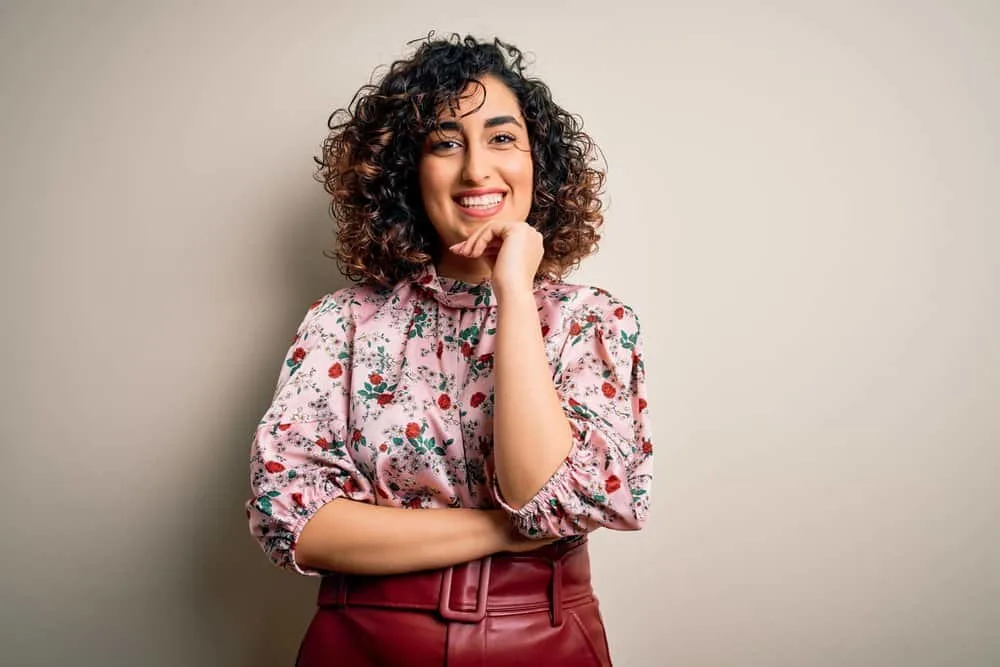 11 Best Hair Color Ideas, Shades, Trends, and Inspo for Women 6 The young woman frames her brown skin with striking face-framing highlights in black and chocolate brown tones.