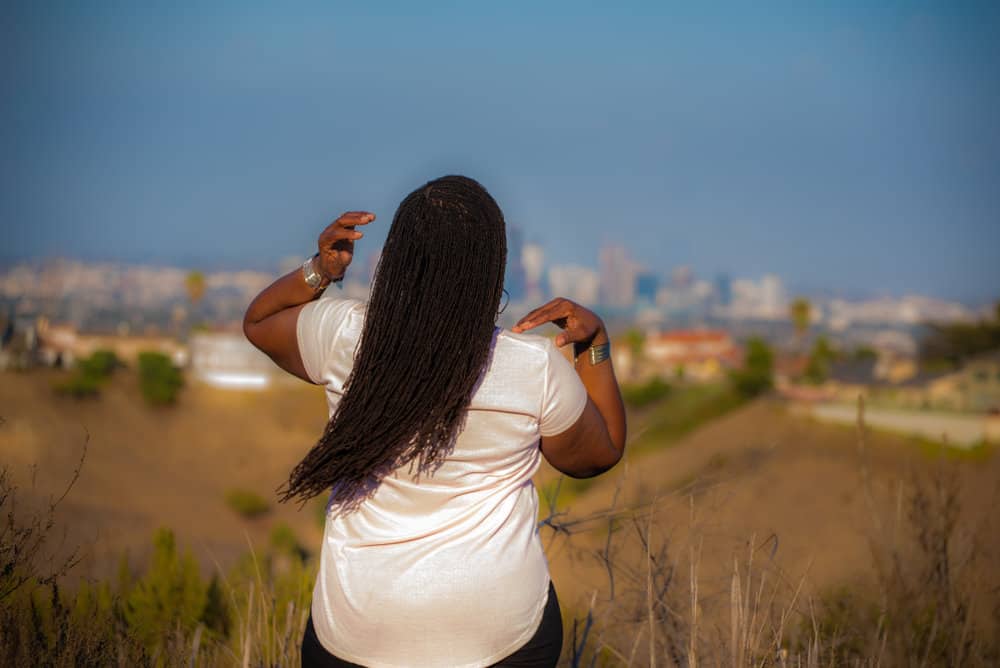 Through two-strand twists and a roller set, these sisterlocks were transformed into a mesmerizing curly natural hairstyle.