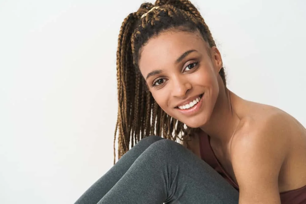 15 Crochet Hair Styles: Ways to Style Crochet Hair for Ladies 1 A cute African female wearing long crochet braids covering her own hair strands with a protective hairstyle.