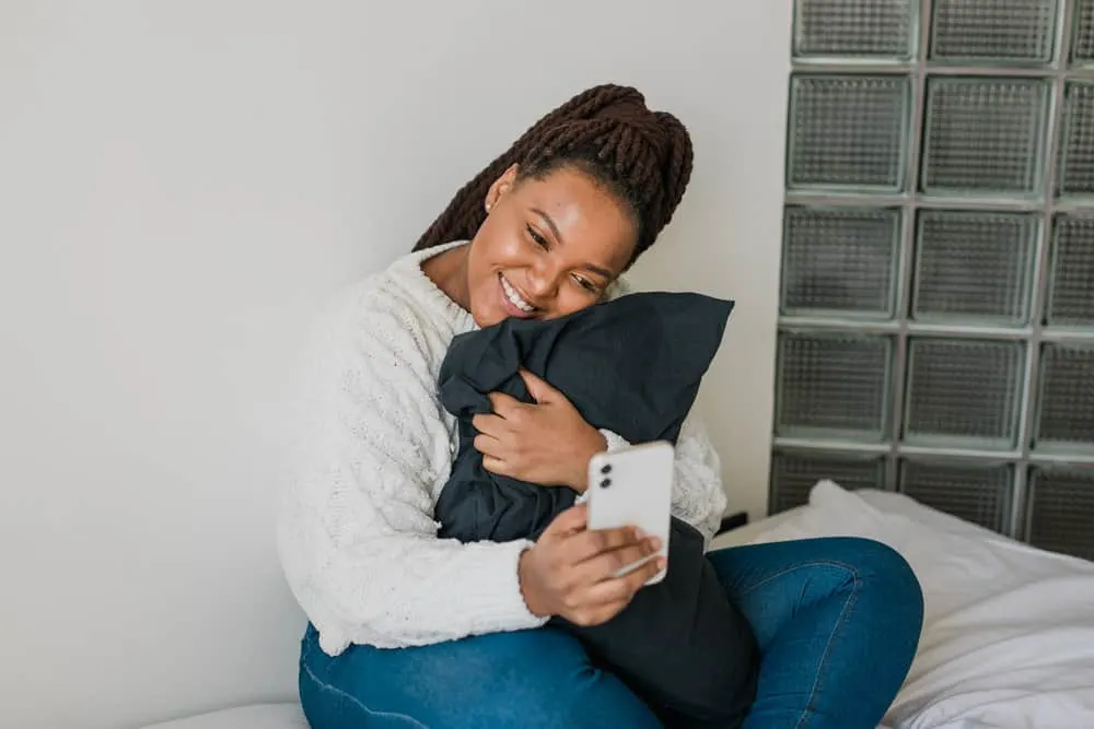 Best Haircuts for Fat Faces and Round, Chubby Double Chins 19 A charming black girl with thick hair wearing a braided hairstyle with black weave adding an extra touch of flair.