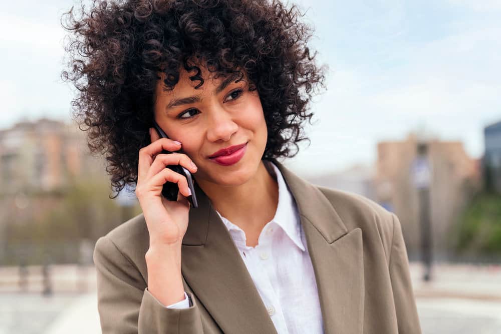 A cute Latin female with thin hair styled with a round brush that can be used on wet or dry hair strands.