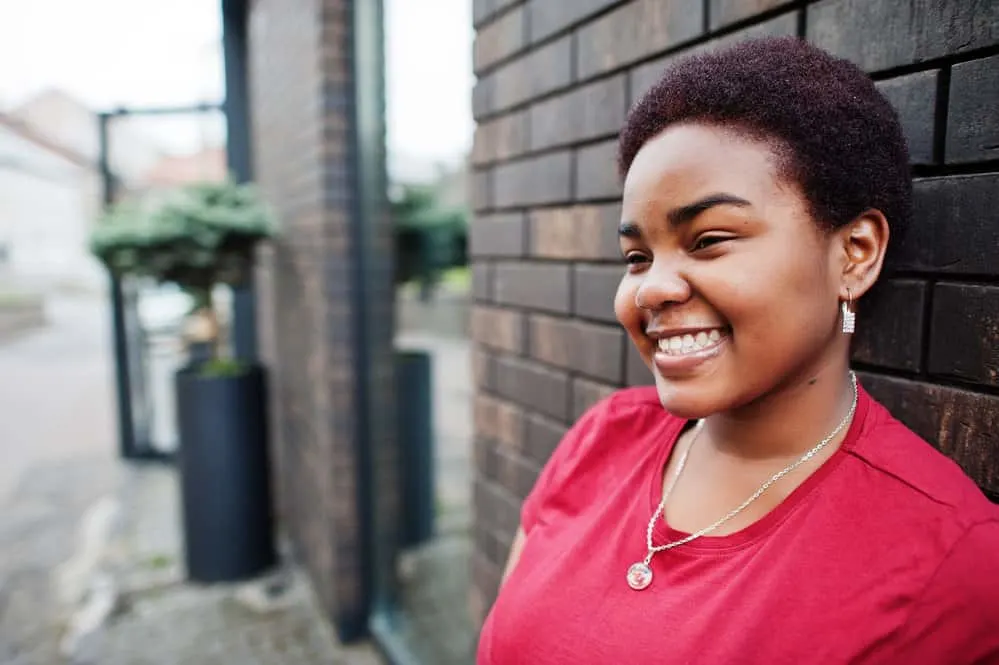 15 Easy and Simple Short Natural Hairstyles for 4C Hair 4 A black girl with a round face wearing a short natural haircut in dyed TWA style after big chopping her long hair.