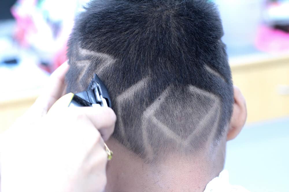 The combination of straight hair and a disconnected-line haircut creates a unique and stylish look for this young boy.