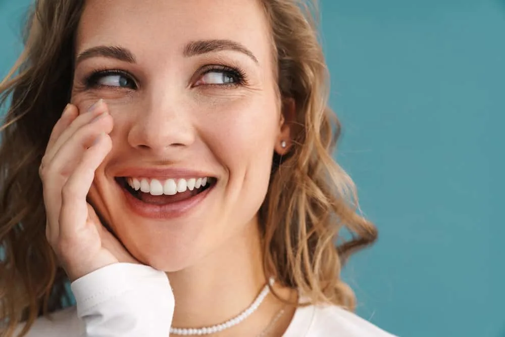 How to Fix Gummy Hair After Bleaching, Perm, or Washing 11 A cute young white woman with a gummy hair feel has been using a deep conditioning treatment to fix the issues.