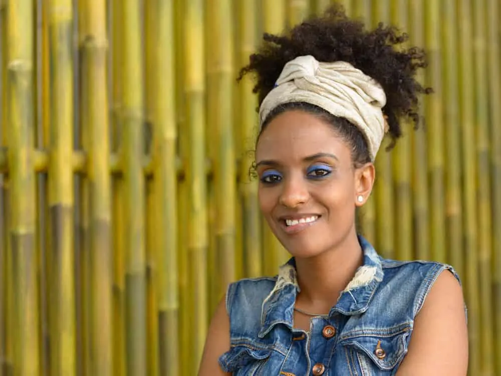 The Best Low-Porosity Hair Oils, How to Use Them & Much More 24 A gorgeous black girl with type 4 hair texture wearing a pineapple hairstyle moisturized with natural hair oil.