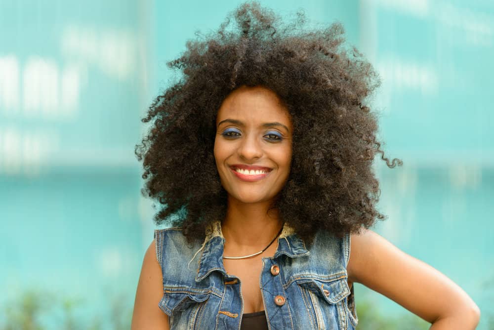 A cute African American female with highly porous hair strands on color-treated hair that won't absorb moisture.