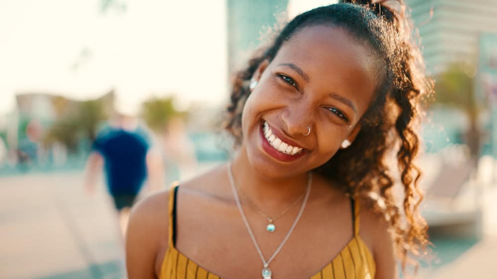 A cute black girl with a great smile has been using rice water for hair care purposes for over a year and a half.