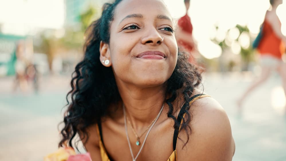 A stunning black girl whose hair care routine involves using an uncooked rice rinse with injected amino acids.