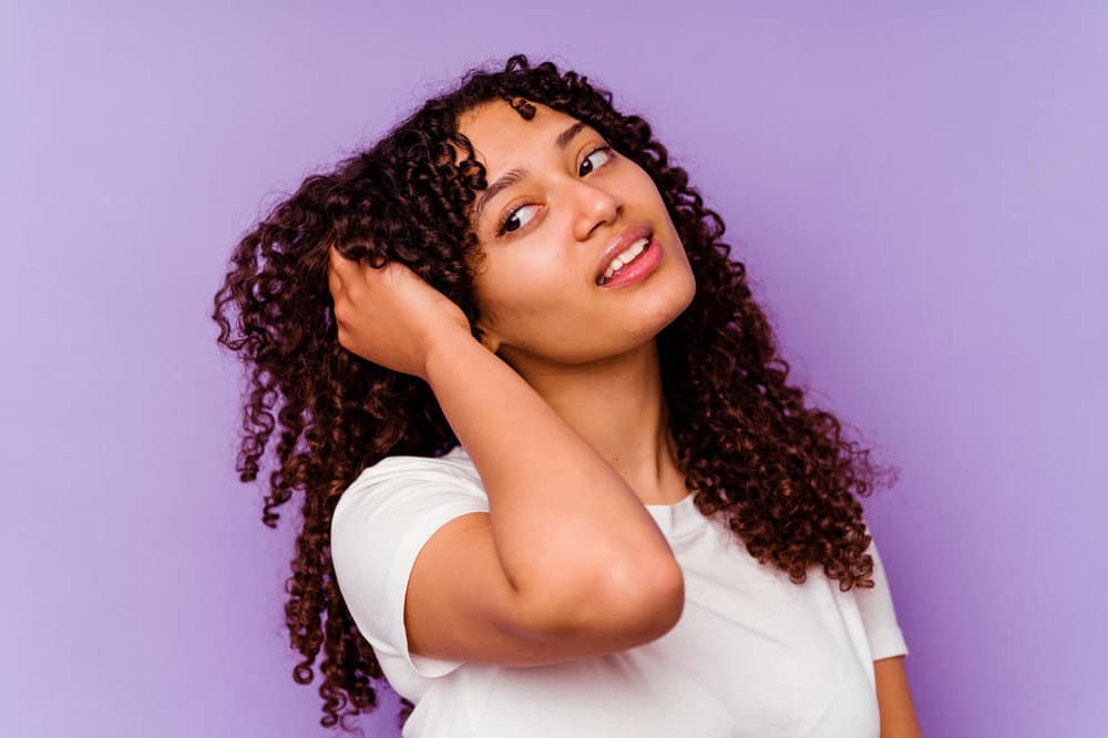 A young black girl is enjoying the potential hair growth benefits from using the Rosmarinus officinalis leaf extract.