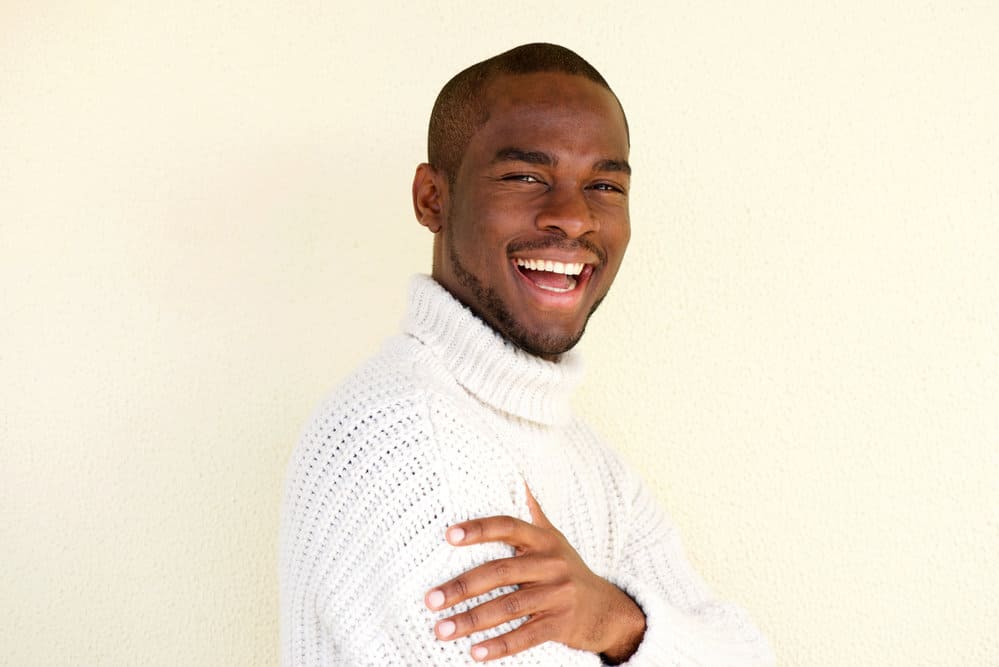 The young African American male with facial hair rocks a military haircut called a flat top that's low maintenance.