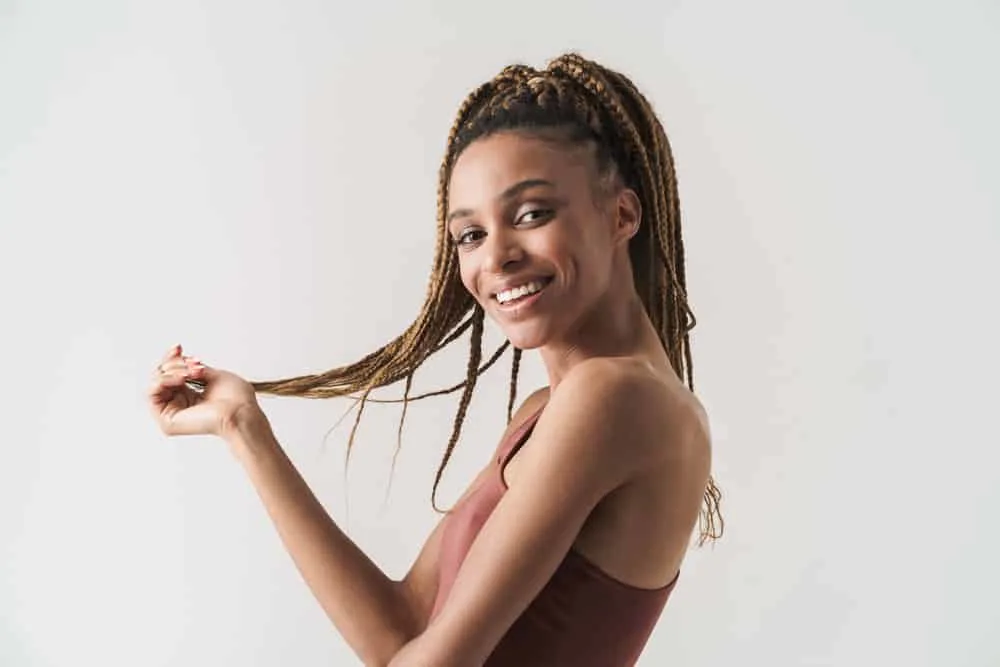 15 Crochet Hair Styles: Ways to Style Crochet Hair for Ladies 2 A light-skinned black girl with wavy crochet hair created with Marley hair complimenting her oval facial features.