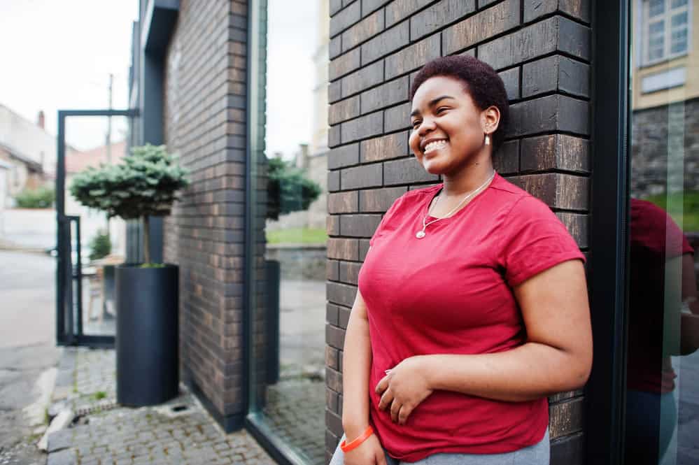 A chubby black girl that used to have longer hair than she does now before cutting it off while going natural.